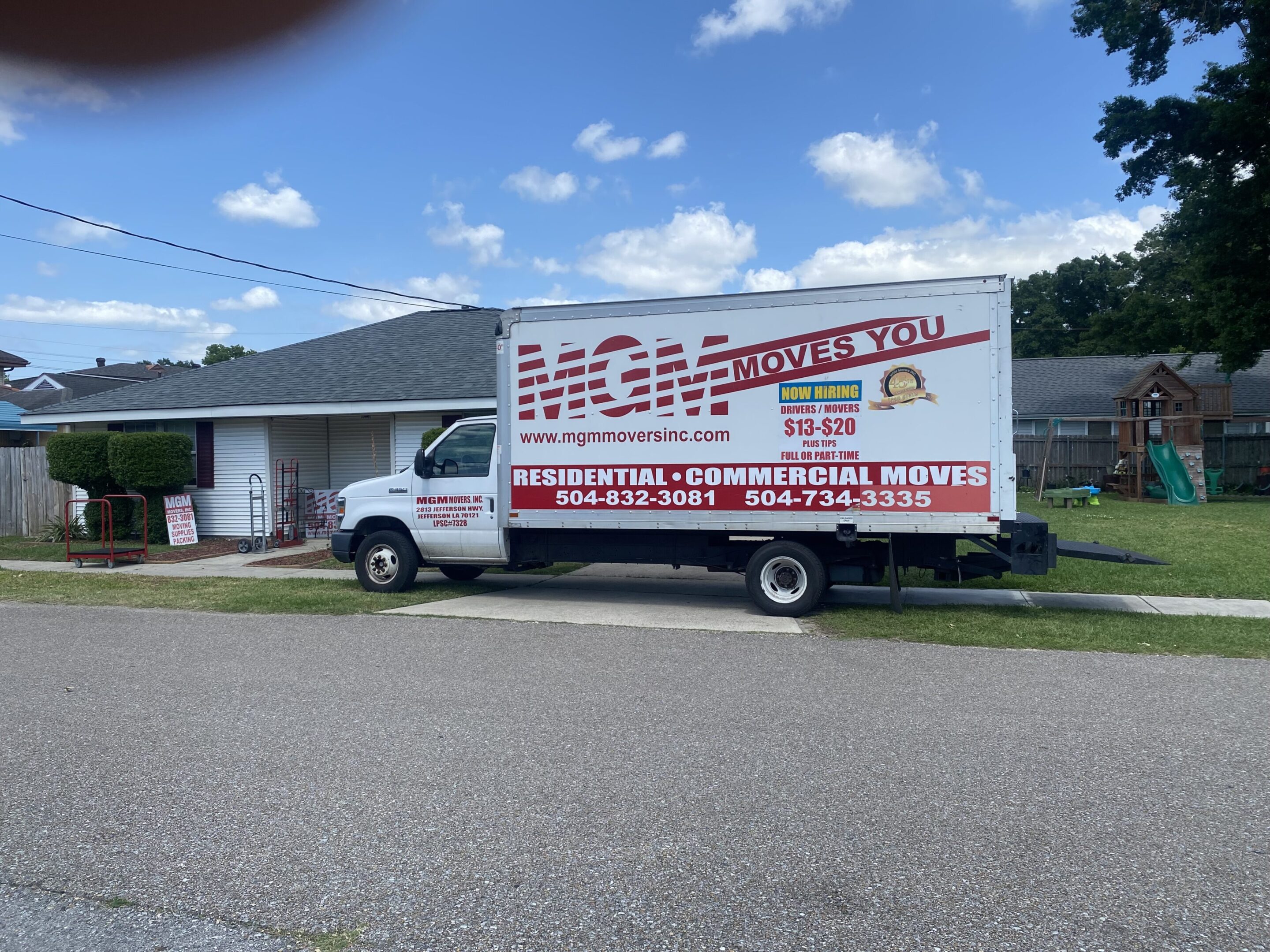 A white truck parked in front of a house.