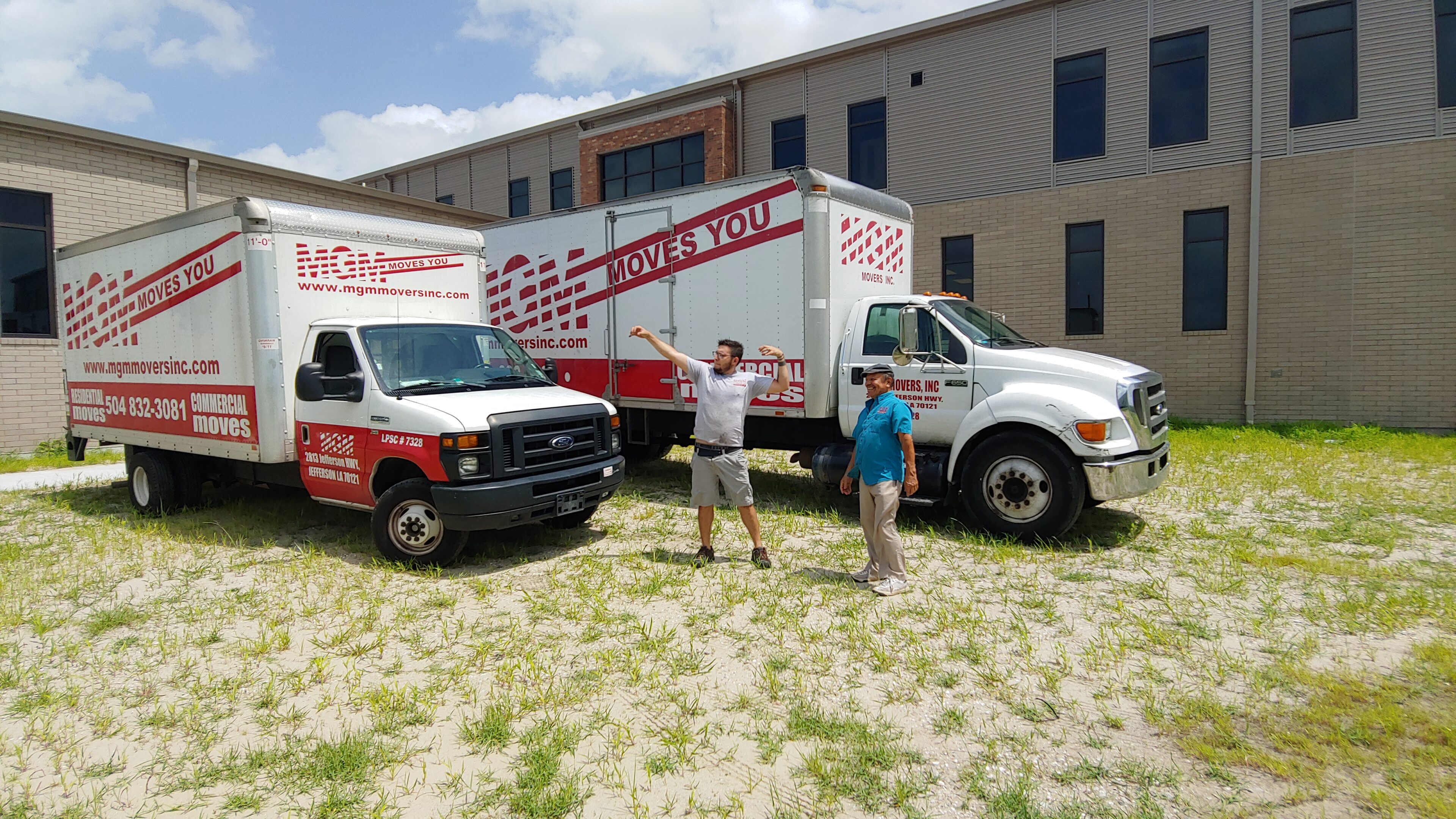 Two men standing in front of a moving truck.