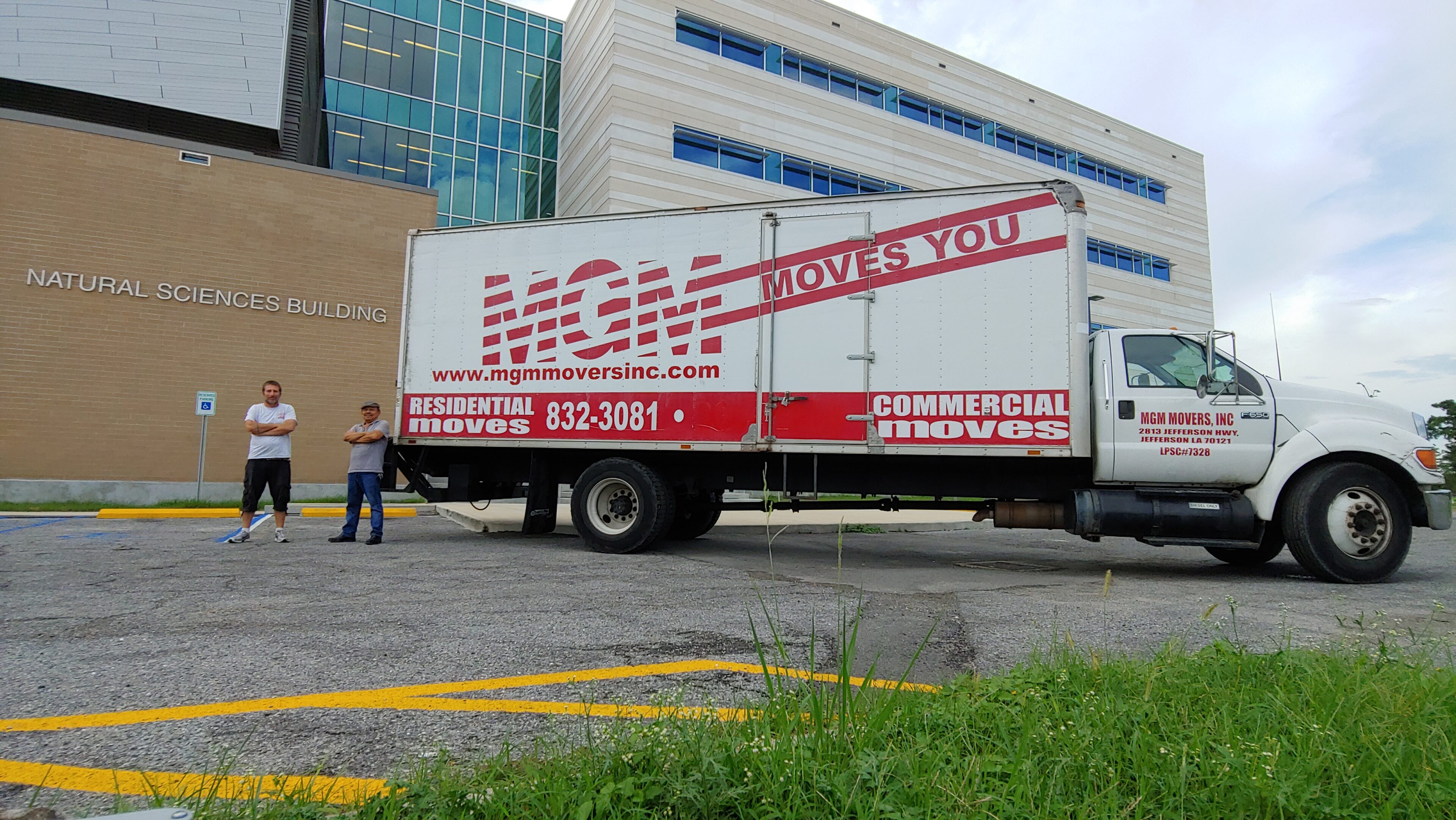 A man standing next to a moving truck.