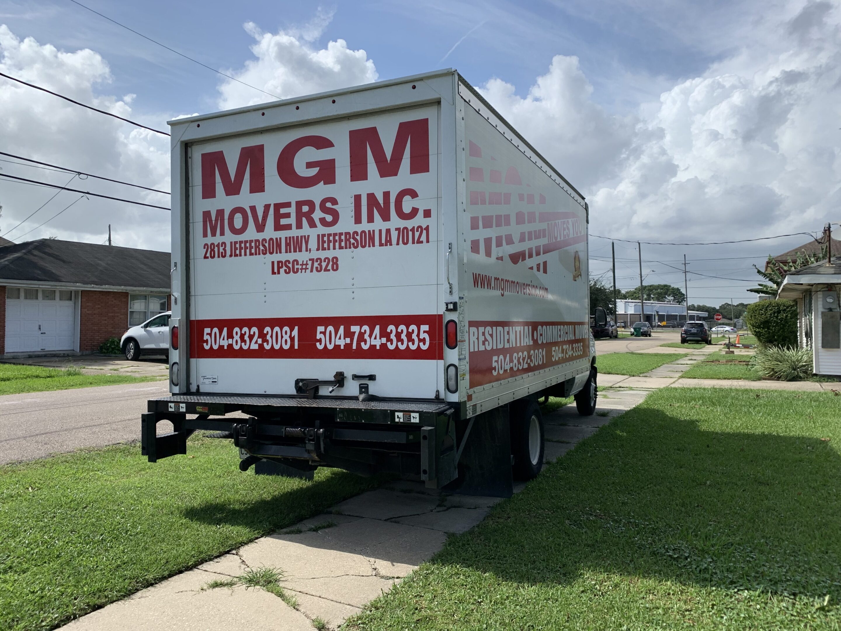 A moving truck parked on the side of a street.