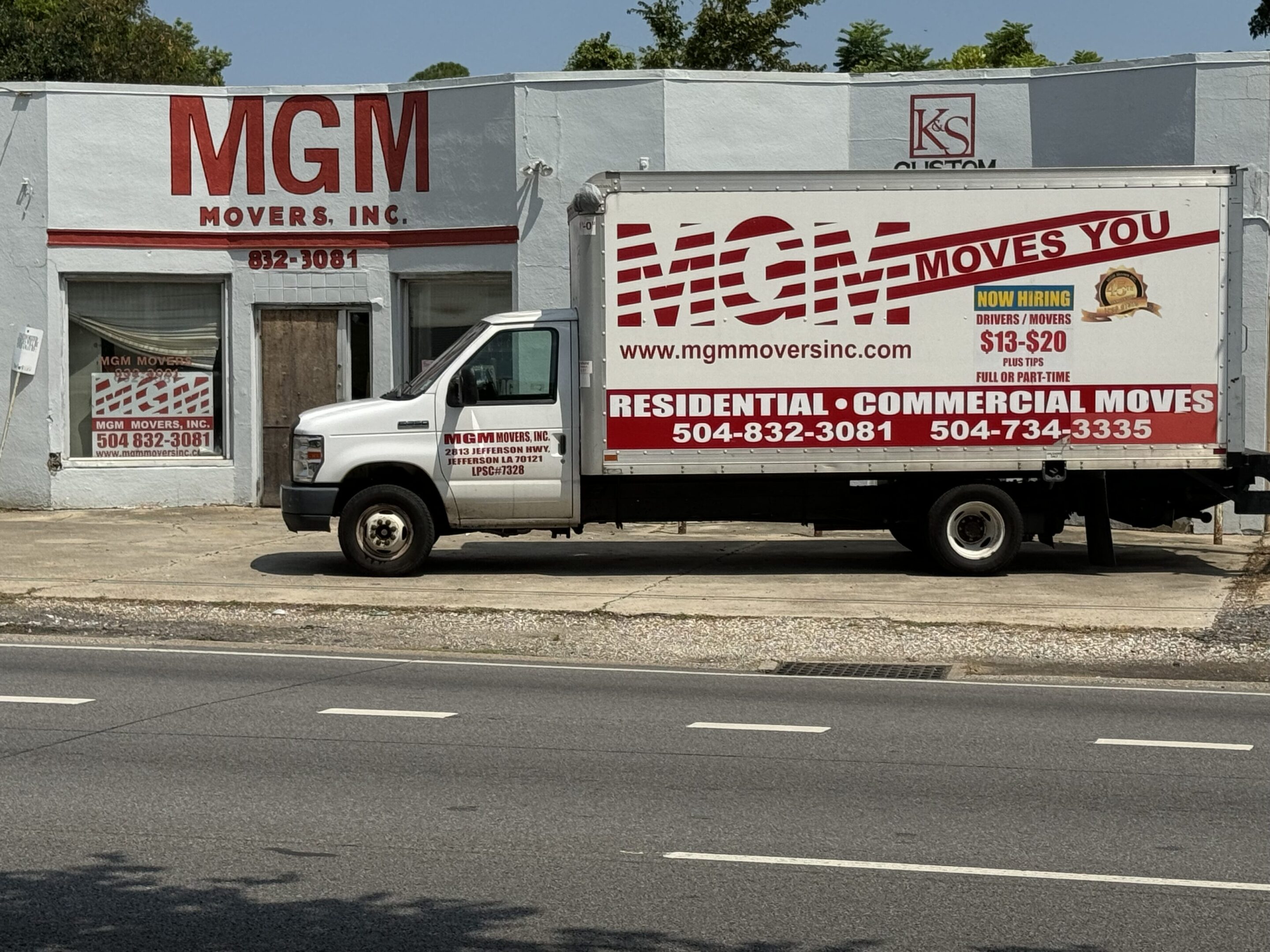 A white truck parked on the side of the road.